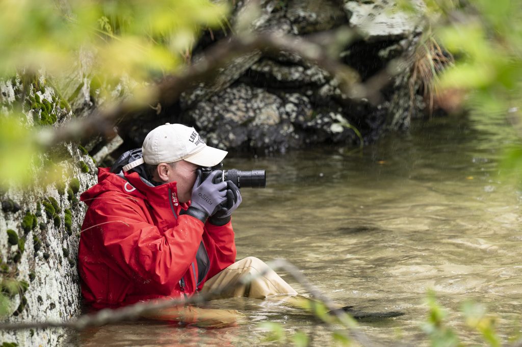 Man taking pictures in water