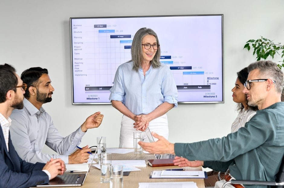 woman presenting to team in office