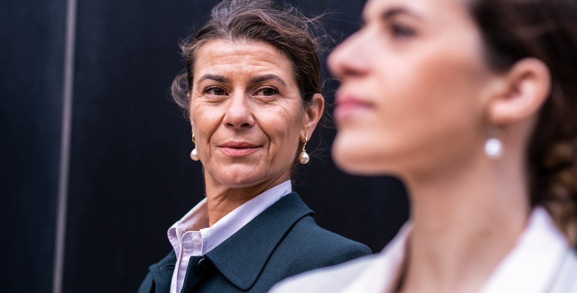 Older woman looking to younger as part of succession plans in business