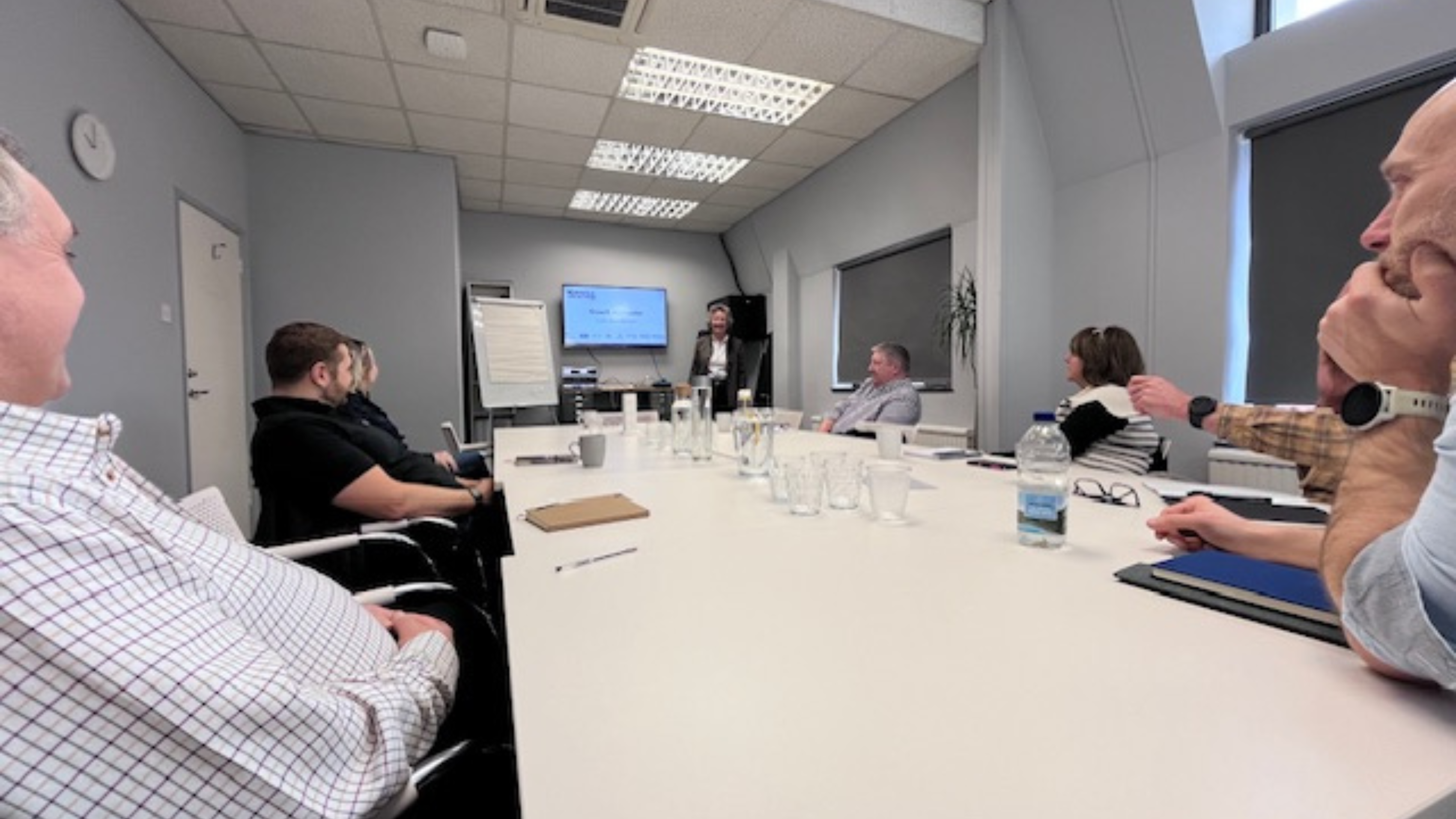 Business owners seated at table in workshop - with bev Hurley CBE 