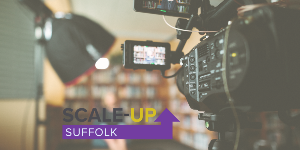 Film camera shown from the POV of standing behind looking towards its subject matter with suffolk scale up logo shown