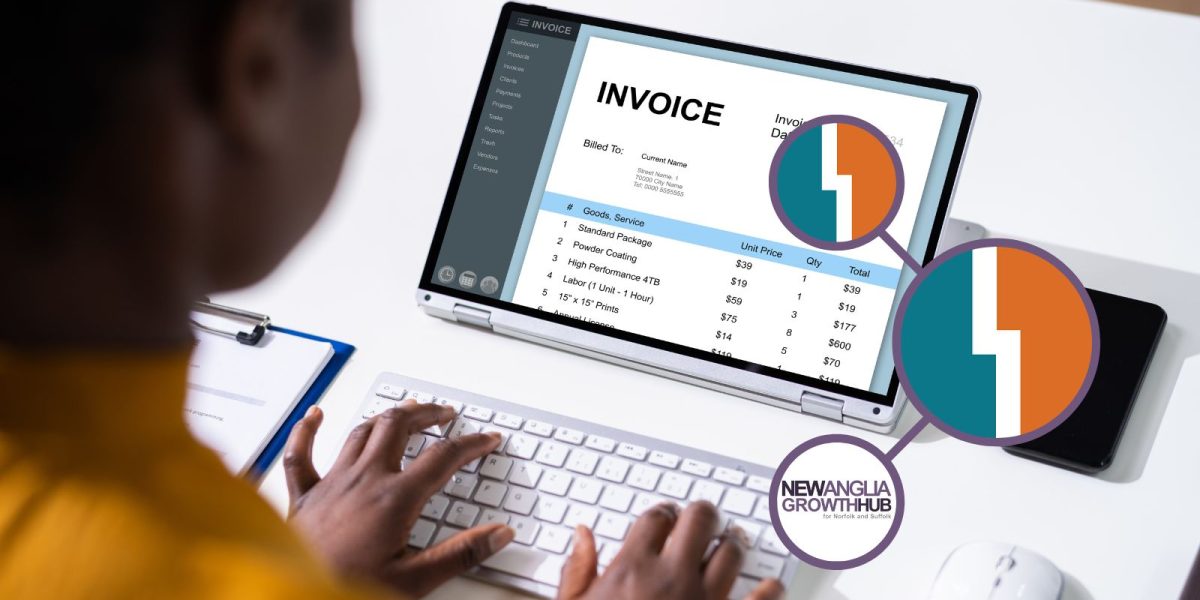 Laptop shown with hands on keypad, the screen has a loaded invoice