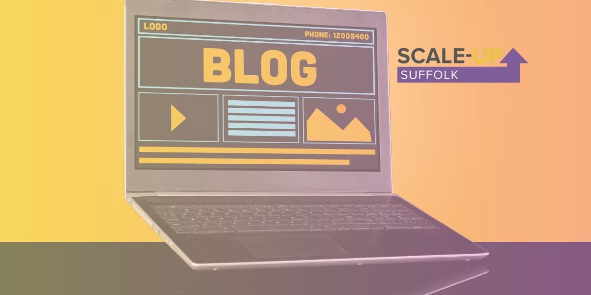Laptop with blog shown on screen and scale up suffolk logo
