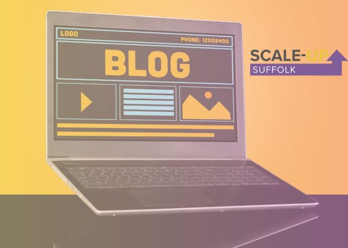 Laptop with blog shown on screen and scale up suffolk logo