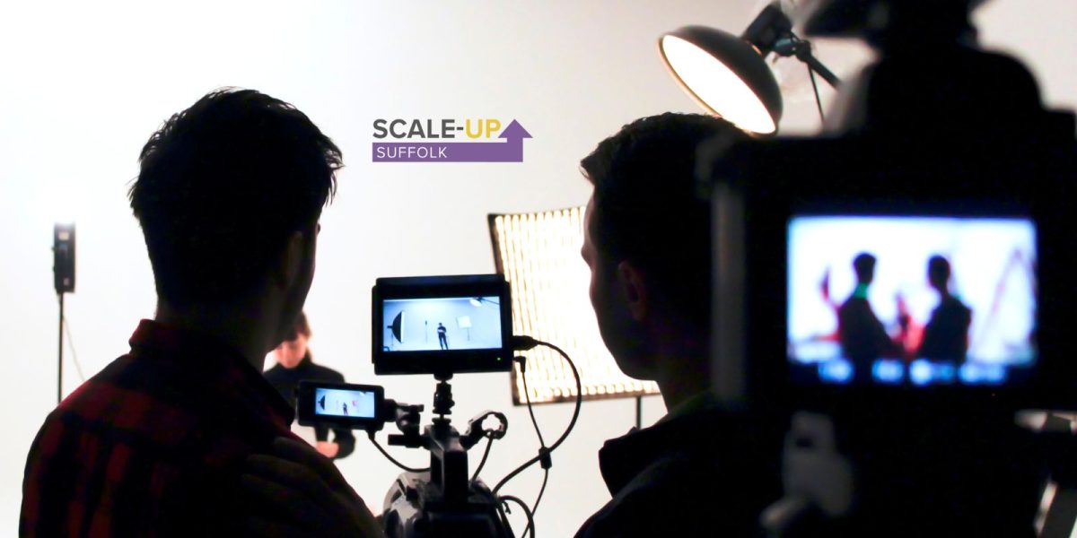 Film set with camera, light and crew shown